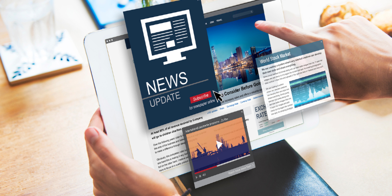 A laptop with news updated and articles popping off the screen that someone is scrolling through.